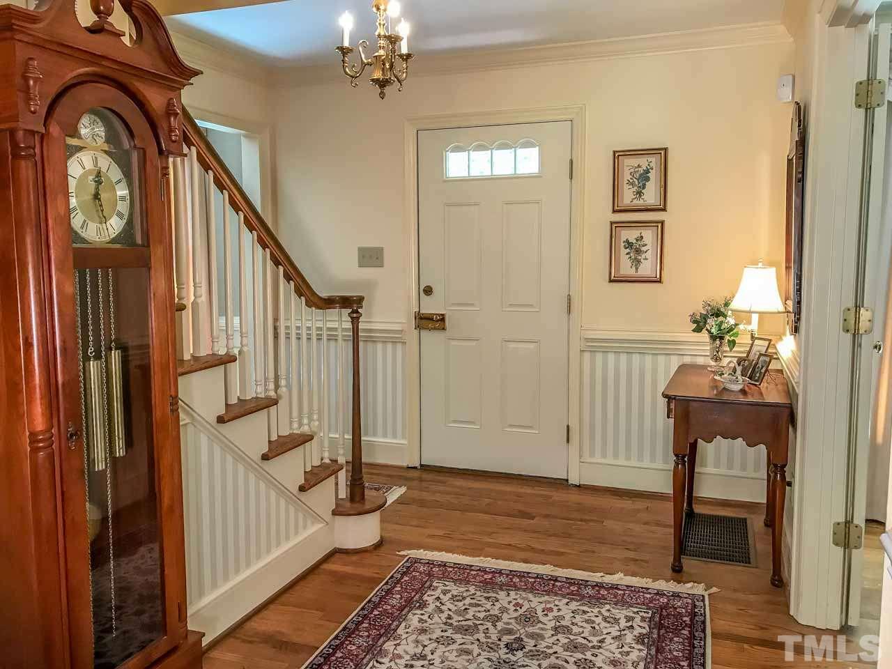 1806 Grande Oaks Road Durham, NC 27712 - Photo 8 of 25 a view of an entryway with wooden floor and a livingroom