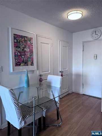 a view of a dining room with furniture a chandelier and wooden floor