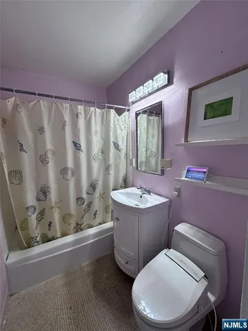a bathroom with a toilet a sink and a shower