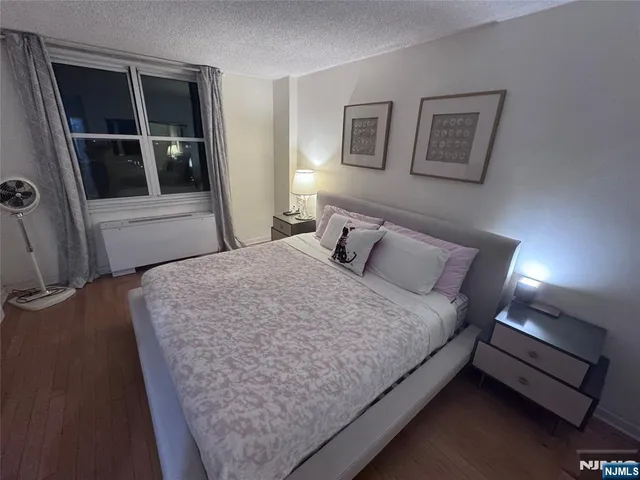 a bedroom with bed and window