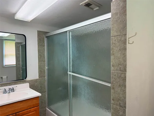 a bathroom with a shower and a sink