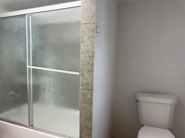 a bathroom with a shower and toilet