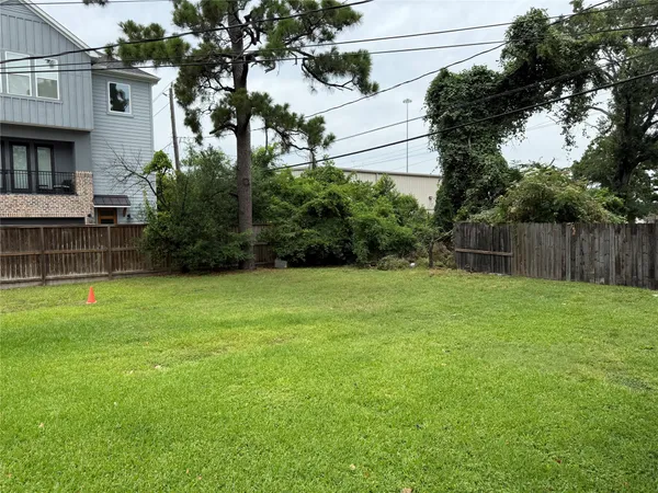 a view of backyard with seating and green space