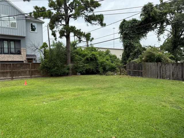 a view of backyard with seating and green space