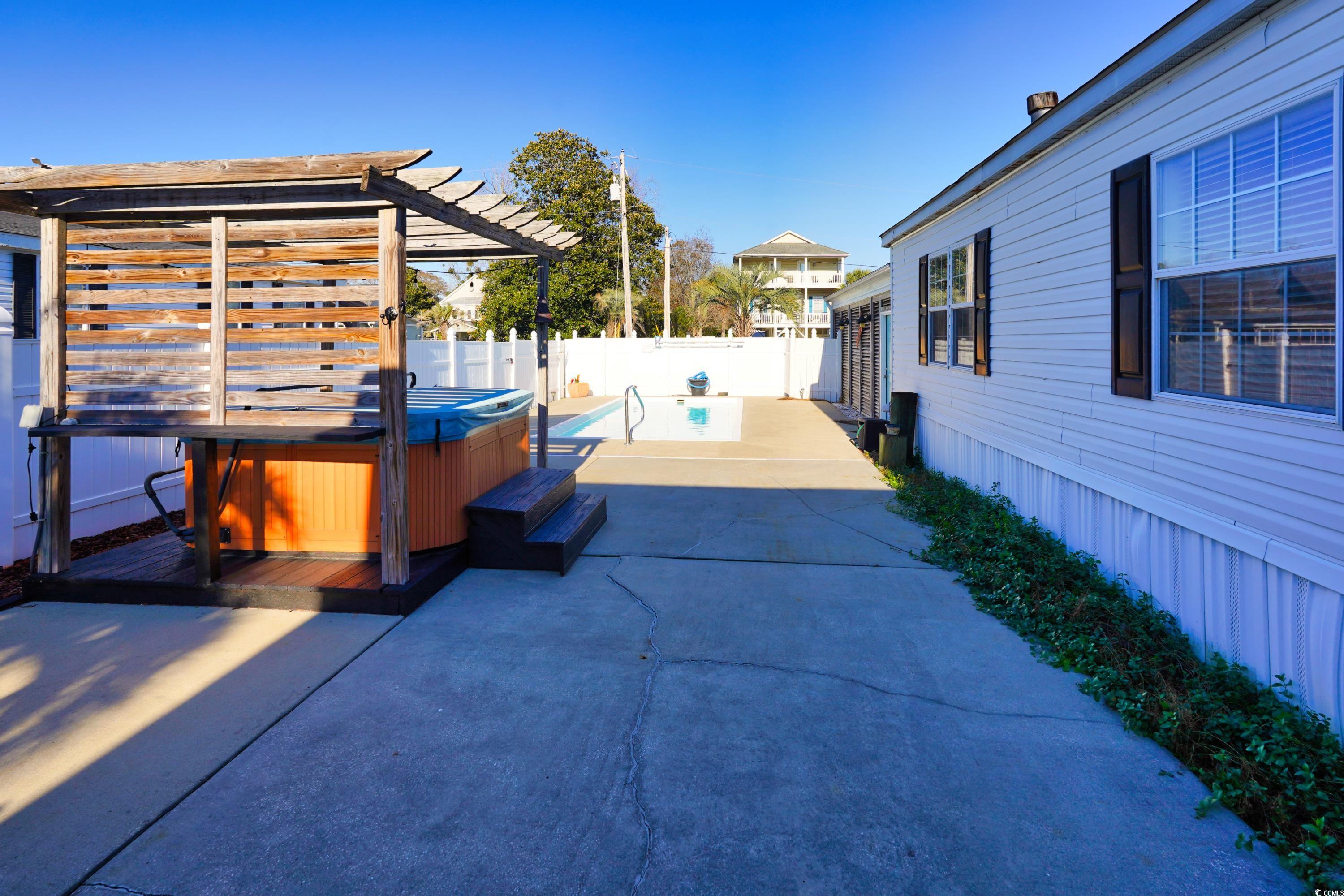 505 Rainbow Drive Murrells Inlet, SC 29576 - Photo 21 of 35 View of patio with a hot tub and a pergola
