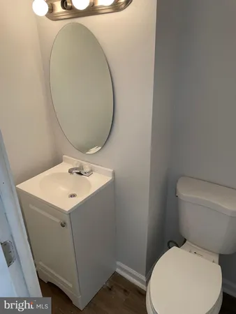 a white toilet sitting next to a bathroom sink