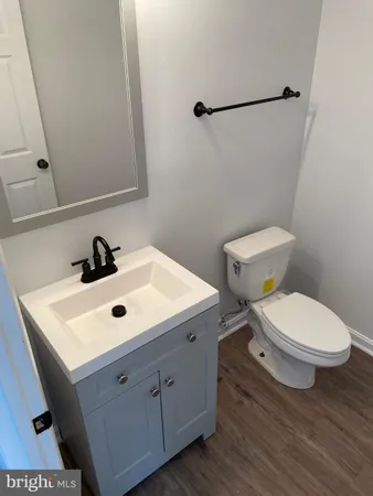 a bathroom with a toilet a sink and mirror