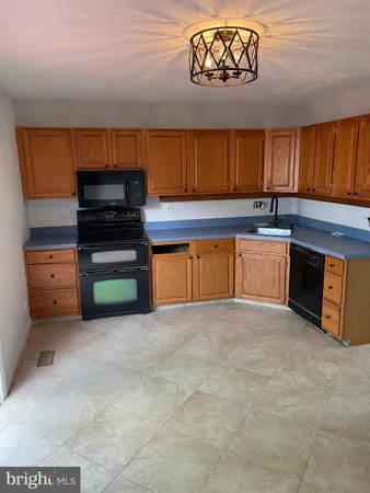 a kitchen with stainless steel appliances a stove a sink and a microwave