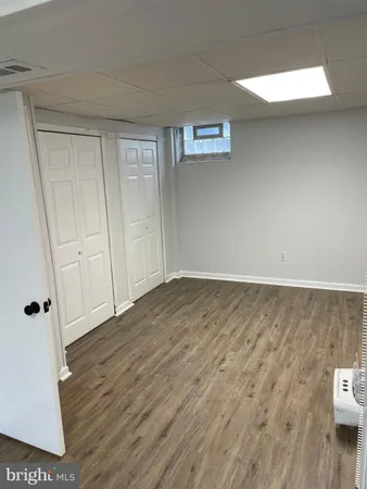 wooden floor in a hall with an empty room
