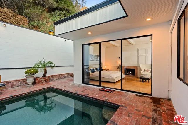 a bathroom with a bathtub shower sink and mirror