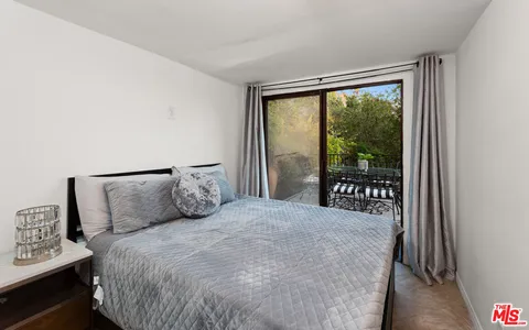 a view of a patio with table and chairs and potted plants