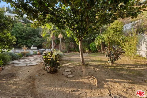 an aerial view of a house with a yard and outdoor seating