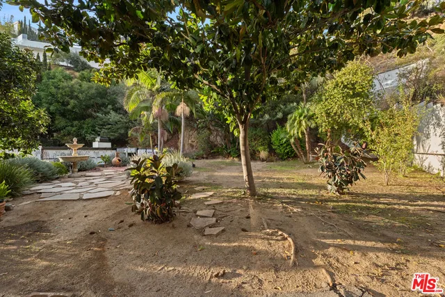 an aerial view of a house with a yard and outdoor seating