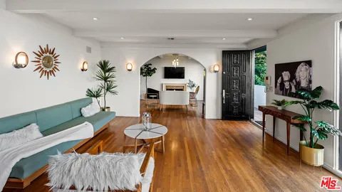 a living room with furniture a dining table and wooden floor