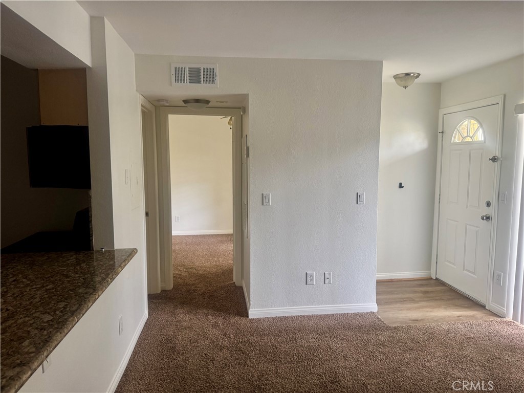 2155 Highpointe Drive Corona, CA 92879 - Photo 3 of 14 a view of a hallway with closet and wooden floor