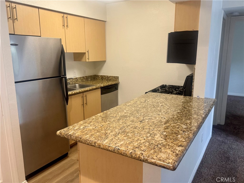 2155 Highpointe Drive Corona, CA 92879 - Photo 6 of 14 a kitchen with a refrigerator and a stove top oven