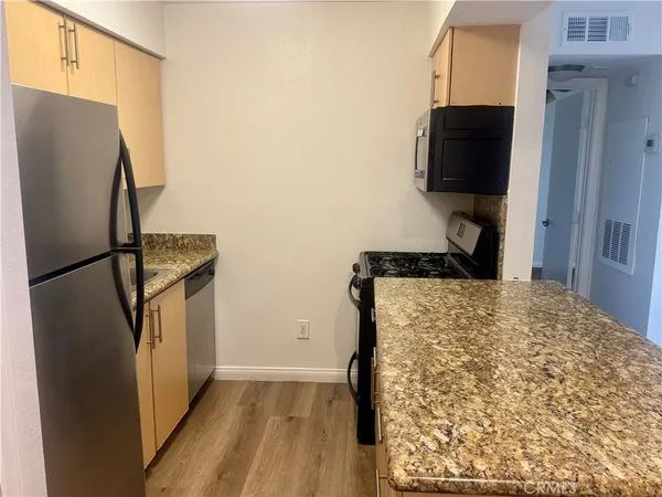 a kitchen with a refrigerator and a stove