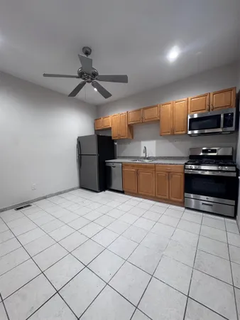 a kitchen with stainless steel appliances a stove a sink and a refrigerator
