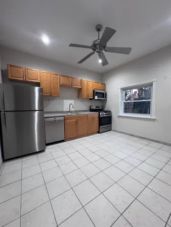 a kitchen with stainless steel appliances granite countertop a refrigerator and a stove top oven