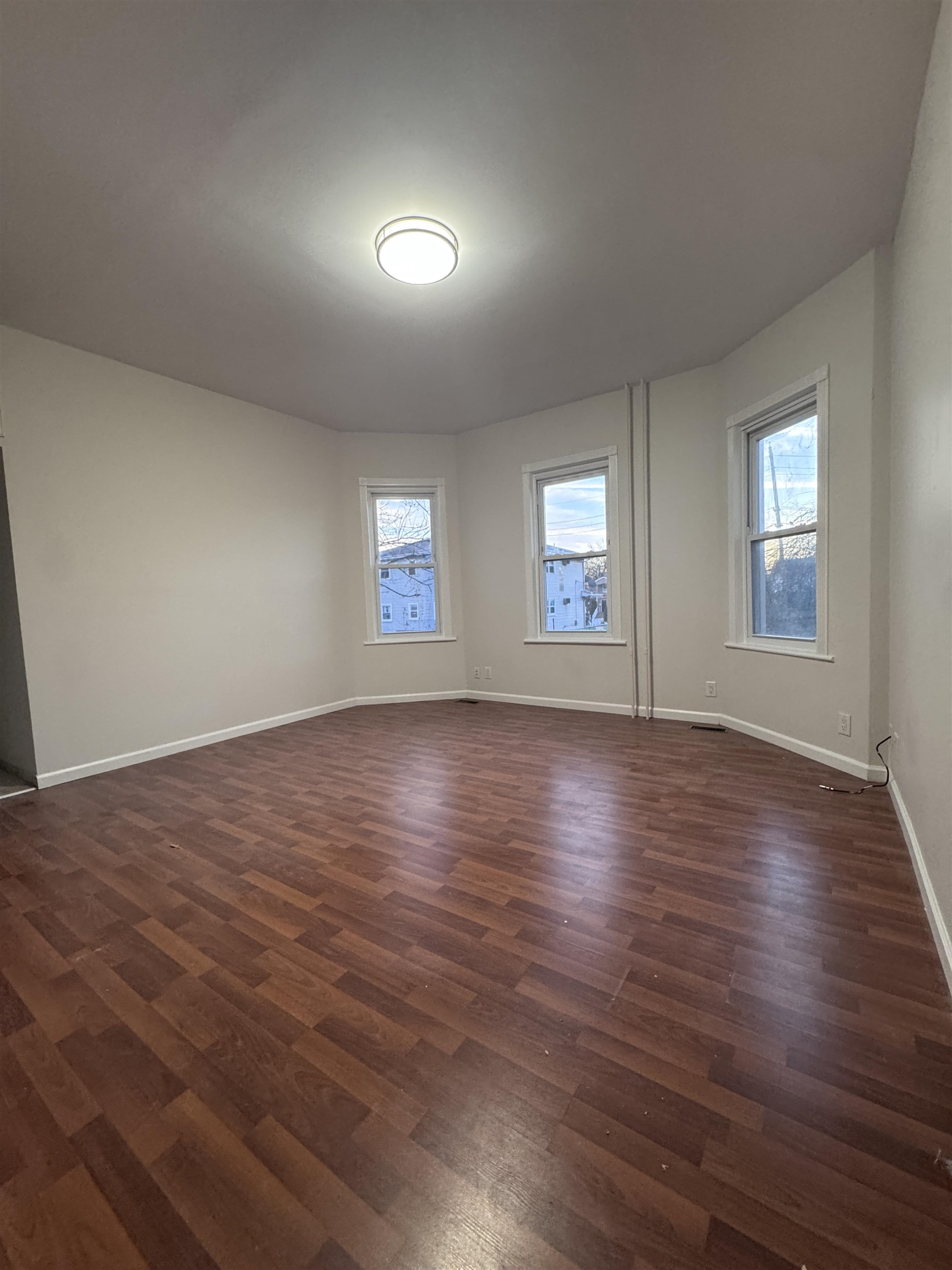 510 Shaler Boulevard, Unit 1 Ridgefield, NJ 07657 - Photo 6 of 10 a view of an empty room with wooden floor and window