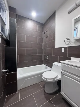 a bathroom with a toilet a sink and bathtub