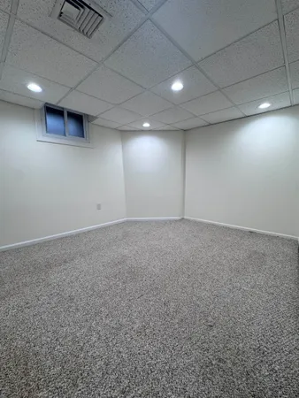 an empty room with lot of wall and a window