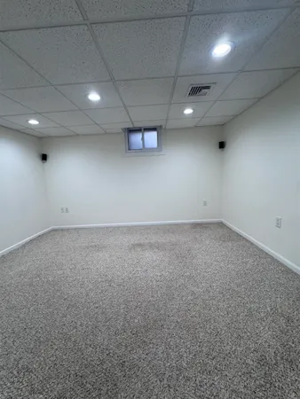 an empty room with a space and windows