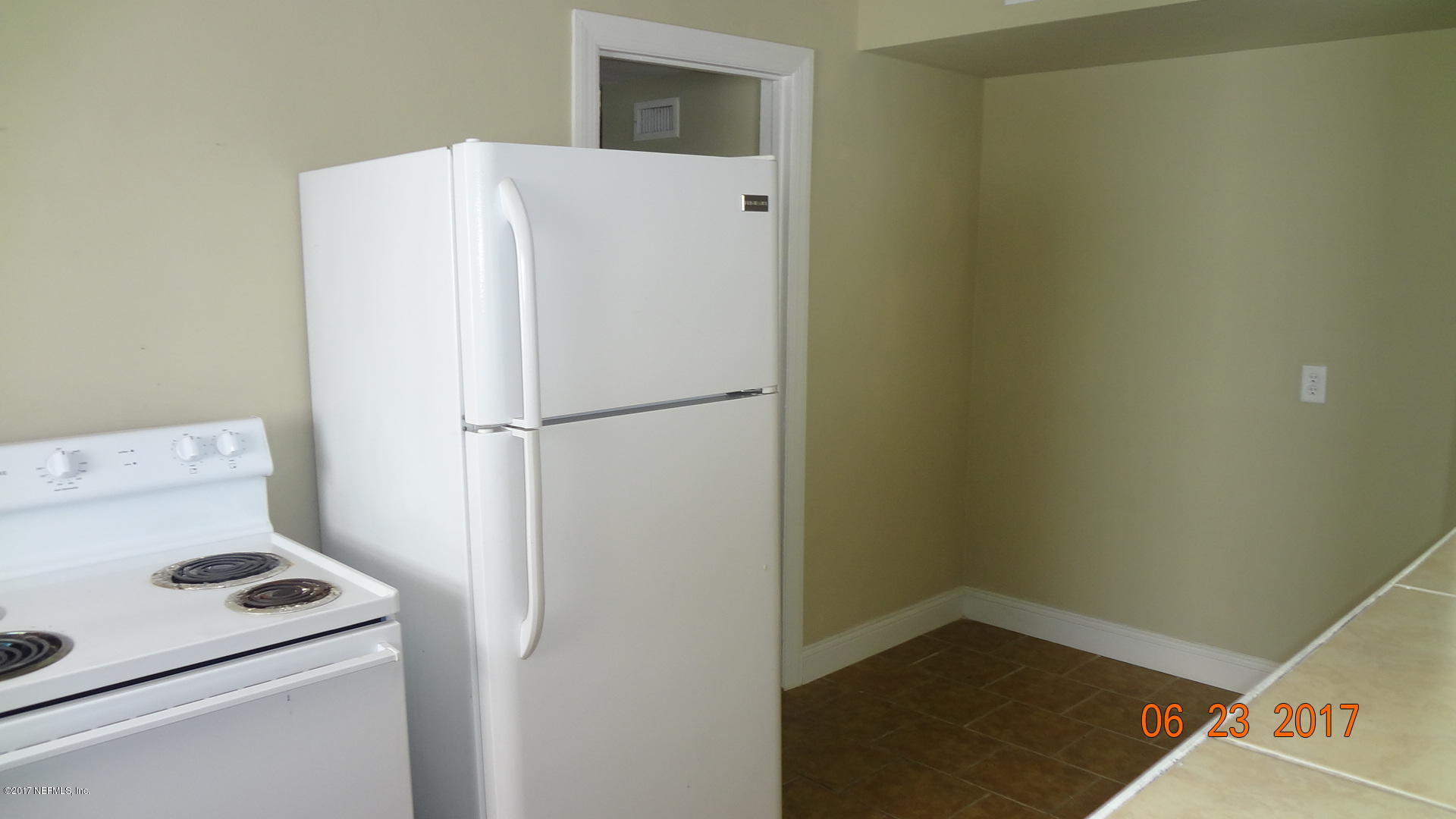 3337 Post Street, Unit 2 Jacksonville, FL 32205 - Photo 4 of 7 a white refrigerator freezer and a stove sitting inside of a kitchen