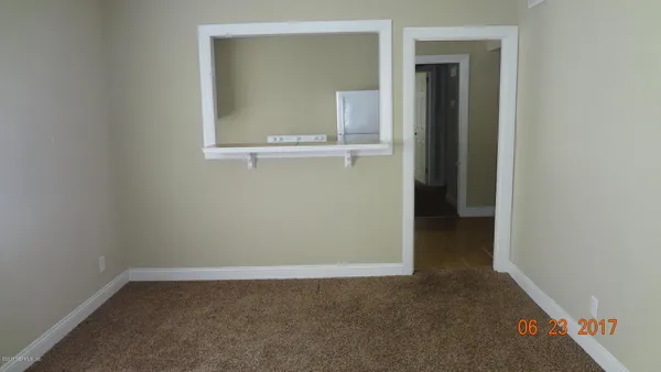 a view of an empty room with a window