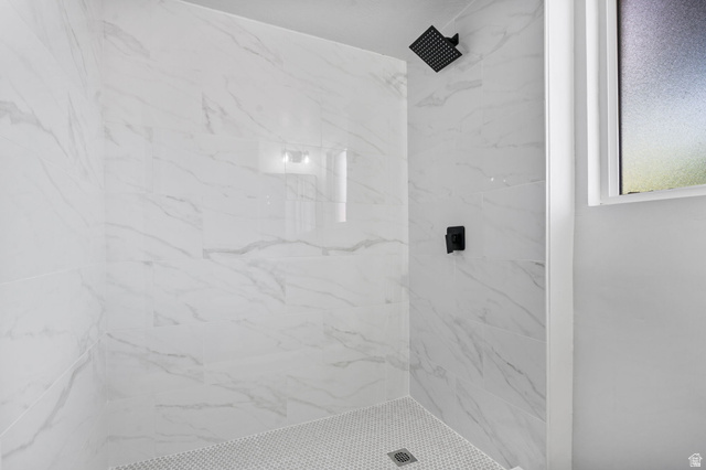 432 Calnette Drive Sandy, UT 84070 - Photo 27 of 48 Walk-in shower featuring white marble-look wall tiling, matte black rainfall showerhead, matte black control handle, and white hexagonal mosaic floor tiling