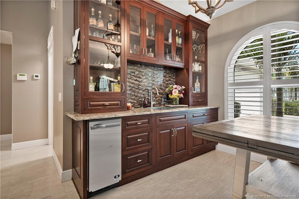 5688 Southeast Pot O Gold Place Stuart, FL 34997 - Photo 12 of 40 a kitchen with stainless steel appliances granite countertop a sink and cabinets