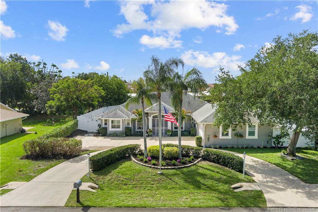 5688 Southeast Pot O Gold Place Stuart, FL 34997 - Photo 2 of 40 a view of a house with a yard