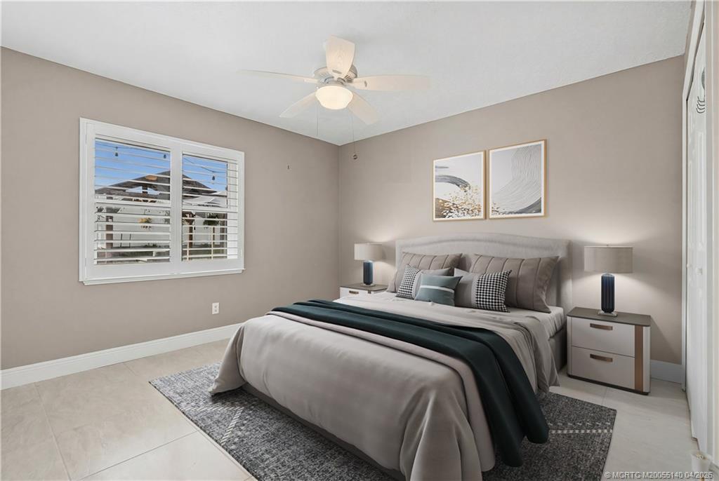 5688 Southeast Pot O Gold Place Stuart, FL 34997 - Photo 26 of 40 a bedroom with bed and a window
