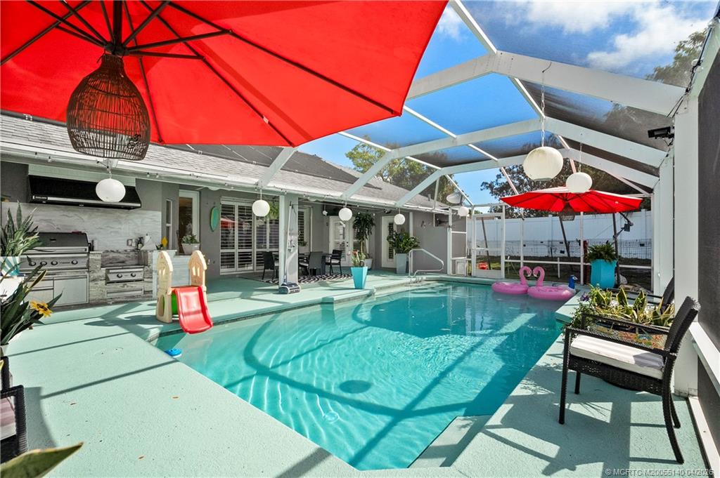 5688 Southeast Pot O Gold Place Stuart, FL 34997 - Photo 33 of 40 a view of a chairs and tables in patio