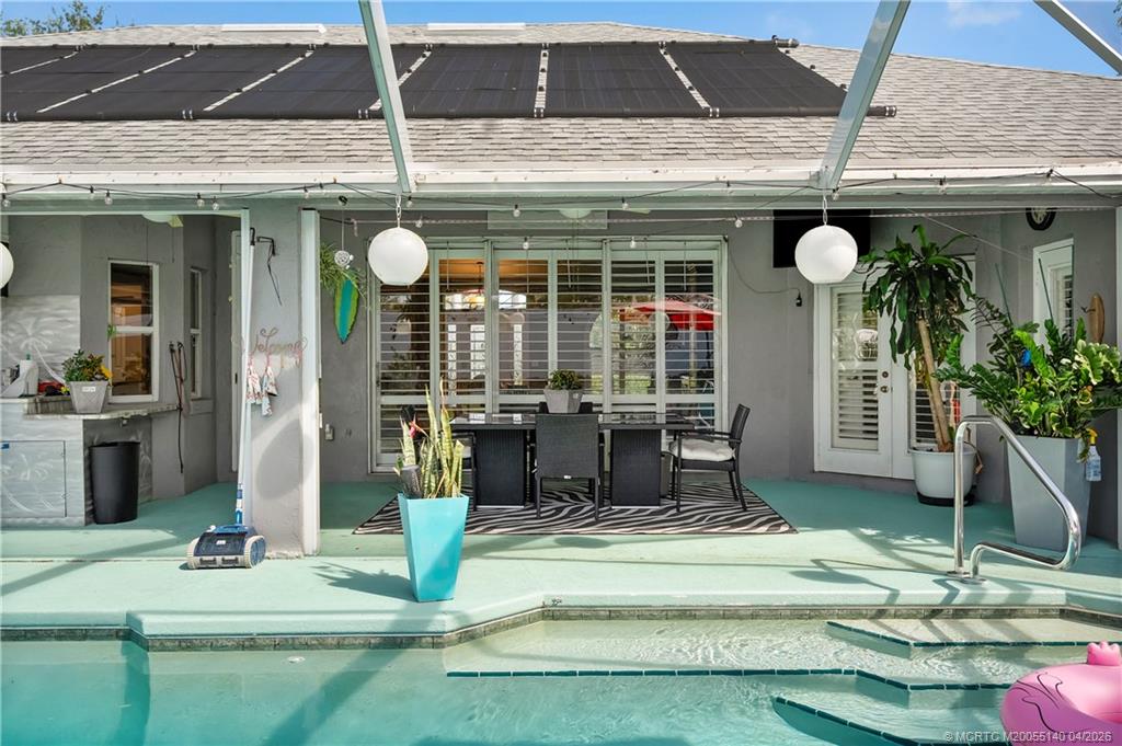 5688 Southeast Pot O Gold Place Stuart, FL 34997 - Photo 34 of 40 a front view of a house with garden