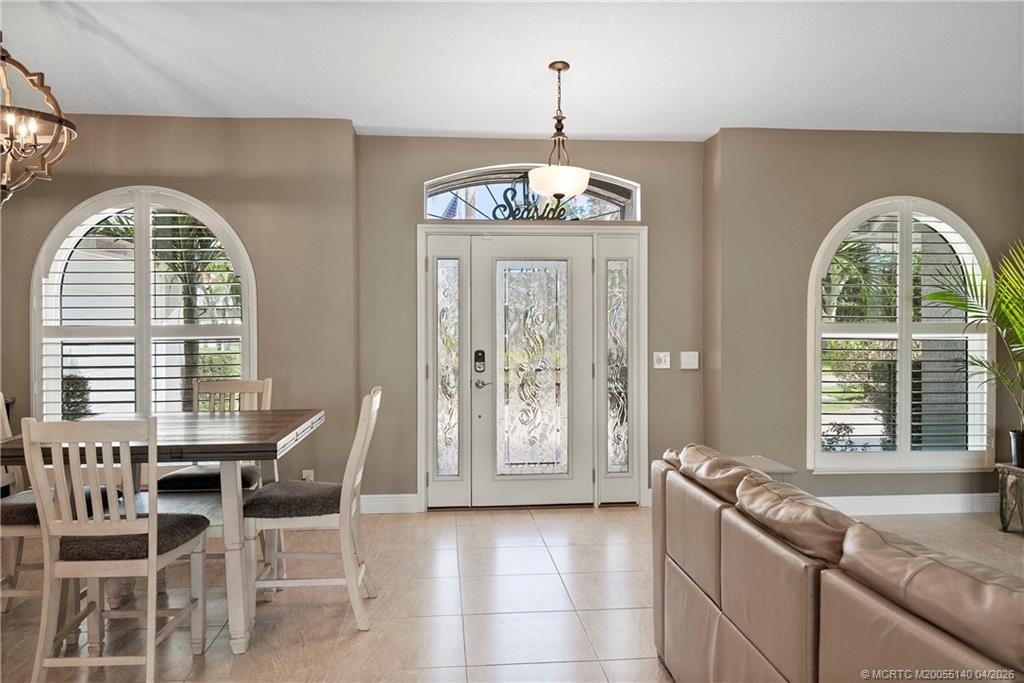 5688 Southeast Pot O Gold Place Stuart, FL 34997 - Photo 6 of 40 a view of a livingroom with furniture window and wooden floor