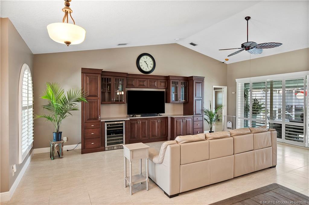 5688 Southeast Pot O Gold Place Stuart, FL 34997 - Photo 7 of 40 a living room with furniture and a flat screen tv