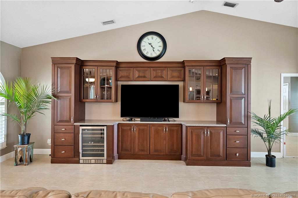 5688 Southeast Pot O Gold Place Stuart, FL 34997 - Photo 8 of 40 a living room with furniture and a flat screen tv