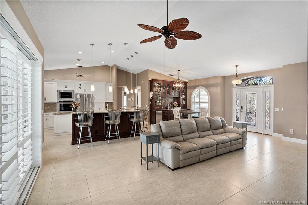 5688 Southeast Pot O Gold Place Stuart, FL 34997 - Photo 10 of 40 a living room with furniture and a view of kitchen