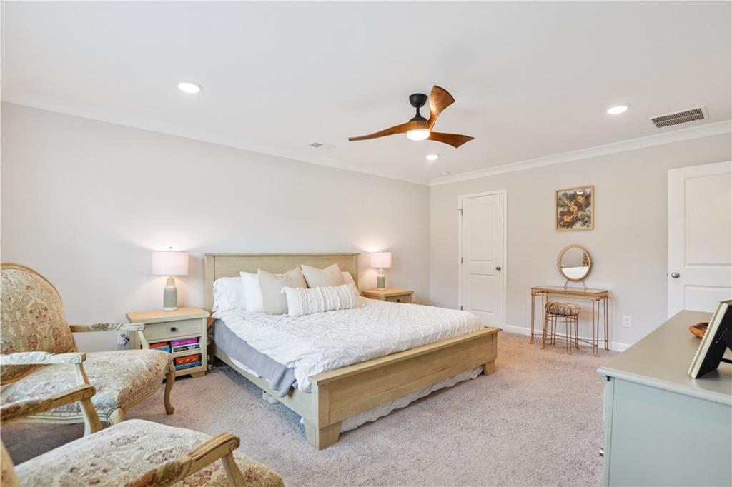 765 Trevett Way Marietta, GA 30066 - Photo 20 of 44 a bedroom with a bed a couch and a chandelier