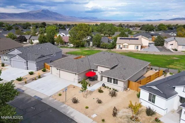 an aerial view of a house with yard swimming pool and outdoor seating