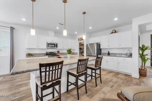 a kitchen with stainless steel appliances granite countertop a sink stove and cabinets