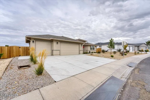 a view of a patio with a table and chairs under an umbrella