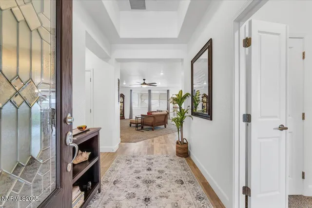 a living room with furniture kitchen view and a chandelier
