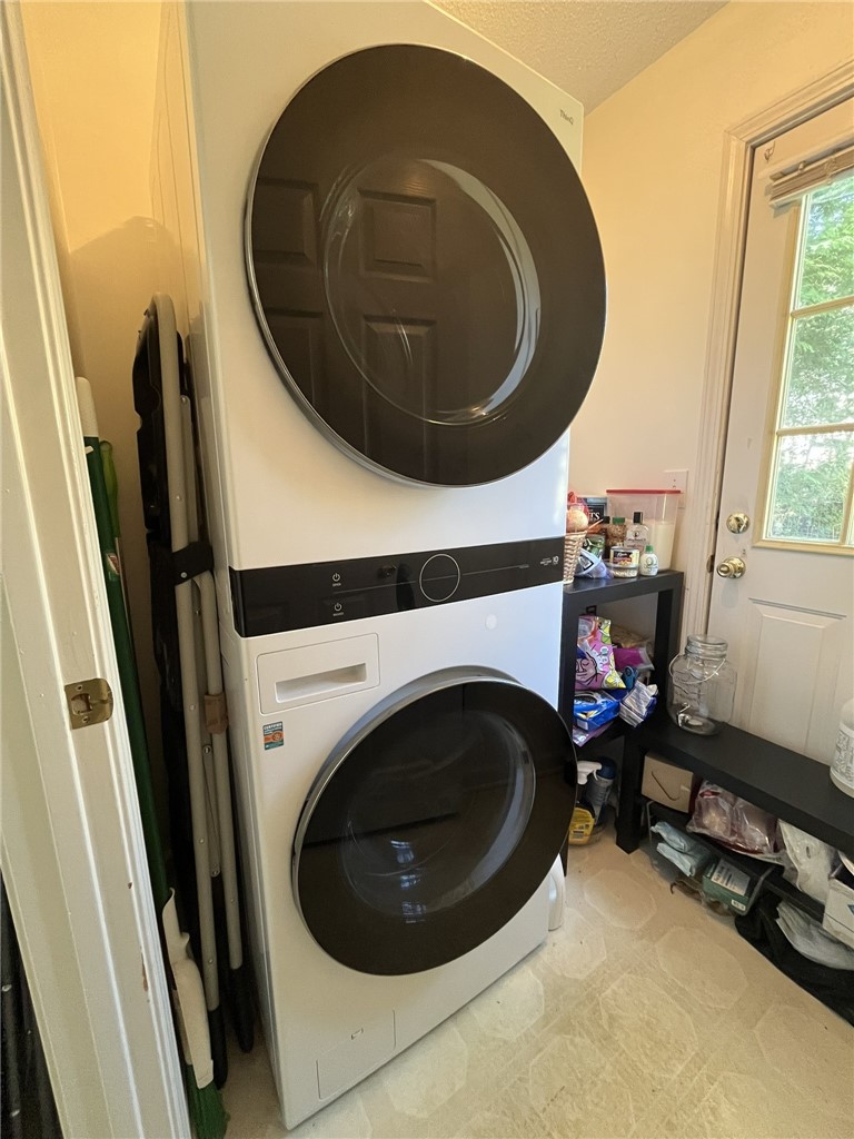 116 Arbors Court Central, SC 29630 - Photo 10 of 27 A well-appointed laundry room features a stacked washer and dryer, optimizing space.