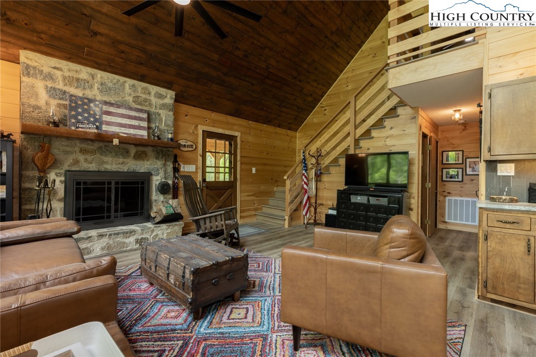 495 Horseshoe Ridge Road East Deep Gap, NC 28618 - Photo 13 of 33 a living room with furniture a flat screen tv and a fireplace