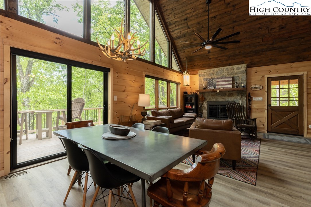 495 Horseshoe Ridge Road East Deep Gap, NC 28618 - Photo 17 of 33 a view of a dining room with furniture window and wooden floor