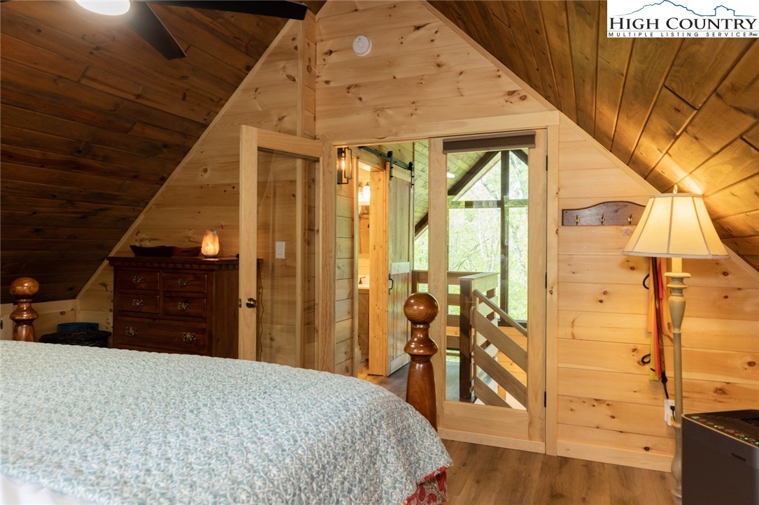 495 Horseshoe Ridge Road East Deep Gap, NC 28618 - Photo 23 of 33 a bedroom with a bed and wooden floor