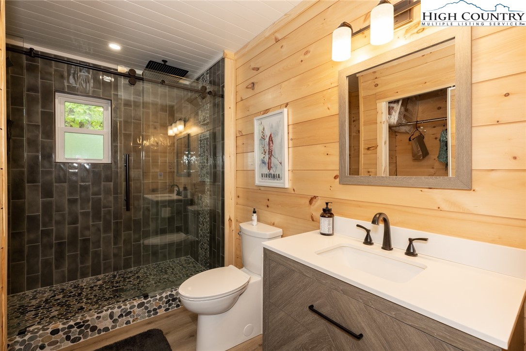 495 Horseshoe Ridge Road East Deep Gap, NC 28618 - Photo 25 of 33 a bathroom with a sink toilet a mirror and shower