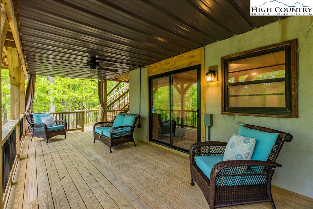 495 Horseshoe Ridge Road East Deep Gap, NC 28618 - Photo 32 of 33 a balcony with furniture and wooden floor